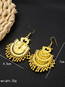 Detailed view of golden bohemian bell earrings with 4.5cm width and 7cm height