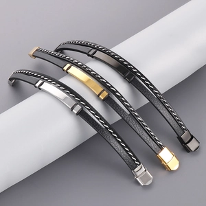 Close-up of woven leather bracelets with gold, silver and black stainless steel clasps