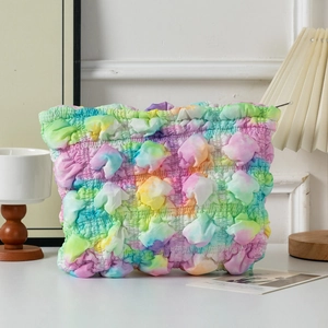 Detail shot of a rainbow bubble pleated cosmetic bag with unique 3D crinkle texture