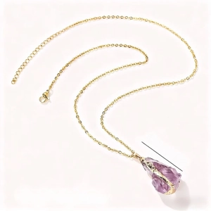 Natural amethyst raw stone necklace with gold-plated chain on a clean white background