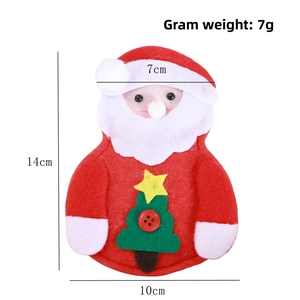Detailed view of handmade Santa felt cutlery holder with green tree and red button