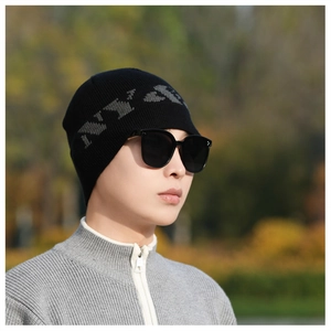 Close-up of black knitted beanie with grey NY jacquard pattern for winter outdoor wear