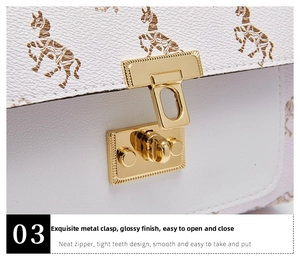 Close-up of golden swivel lock and horse print detail on white leather mini bag