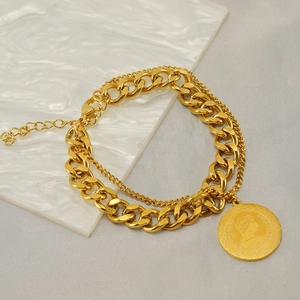 Double-layer gold Cuban link chain bracelet with a round coin pendant and lobster clasp