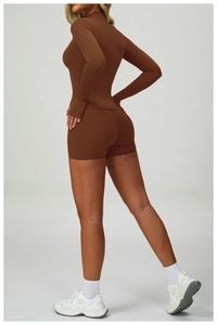 Detail of slim fit brown long sleeve yoga top and high waist shorts from a side view
