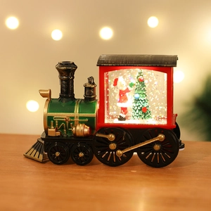 Close-up of vintage Christmas water globe train with Santa Claus and glittery snow