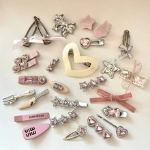Flat lay of pink and silver hair accessory set with bows, stars, and resin charms
