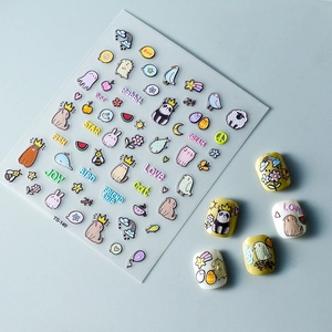 Macro detail of 3D embossed nail stickers featuring cute cartoon dogs and birds motifs