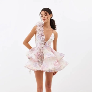 Detail of elegant 3D floral shoulder strap and deep V-neck on a mini tulle dress