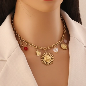 Golden multi-pendant necklace featuring rainbow, sun, and moon charms on a model neck