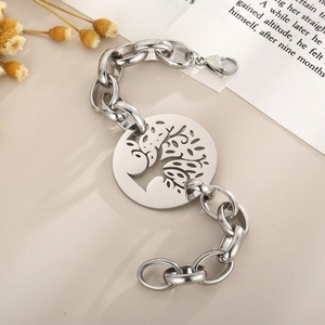 Detail of Tree of Life pendant with chunky O-chain and lobster clasp on beige surface