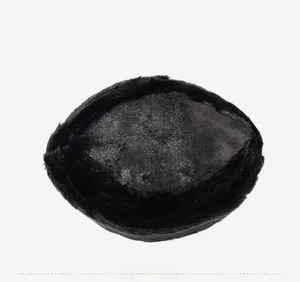 Overhead view of a black faux fur winter hat with dense glossy texture and round top