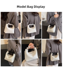 Detailed views of creamy hobo bag with pearl handle and silver chain strap on a model