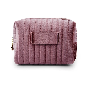 Pink velvet makeup bag with vertical quilted stripes and a metal zipper on white background