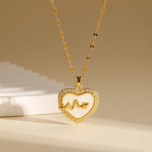 Zircon heart pendant necklace with shell inlay and heartbeat line in gold finish