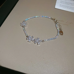 Macro shot of silver flower bracelet with marquise cubic zirconia and lobster clasp