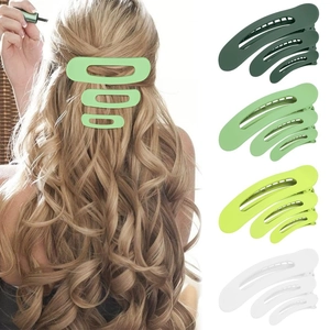 Pinzas para el cabello de plástico mate en cuatro colores y tres tamaños sobre fondo blanco