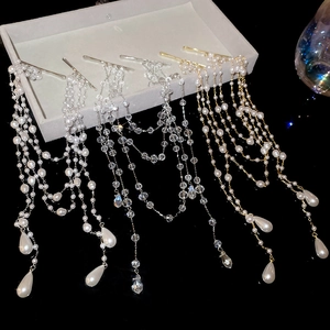 Detail of luxury pearl tassel hair clips with gold and silver chains for women