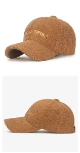 Close-up of brown teddy fleece baseball cap with yellow Beautiful embroidery detail