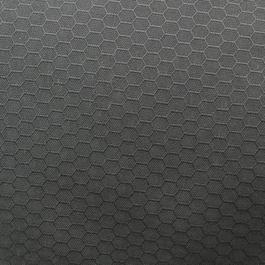 Macro shot of dark grey honeycomb texture on quick-dry breathable baseball cap fabric