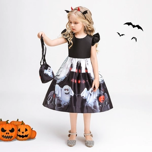 Detail of girl's Halloween pumpkin dress featuring ghost and castle prints with handbag