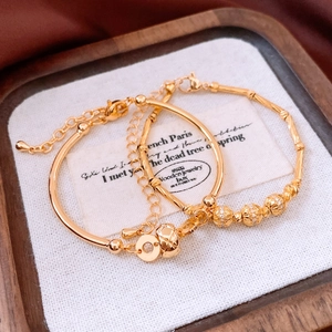 Detailed close-up of 18K gold-plated bamboo bracelet set with micro-inlaid crystals