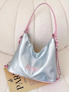 Silver tote bag with pink straps and chain detail on a soft cream background