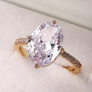 Macro shot of large oval marquise zircon ring with gold band in a velvet box