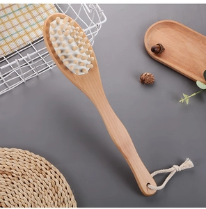 Detail of wooden body massage brush with natural bristles and cotton hanging loop
