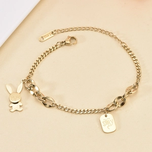 Detail of gold stainless steel snake chain bracelet featuring a cute rabbit charm and tag