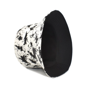 Detail view of double-sided tie-dye bucket hat showing black and white patterns and inner lining
