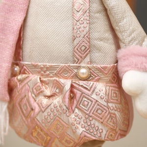 Pink Christmas snowman doll featuring retractable legs and plush jacquard fabric