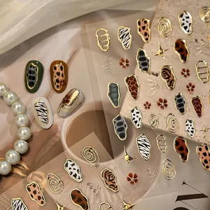 French animal print nail stickers featuring gold embossed zebra, leopard and cow patterns