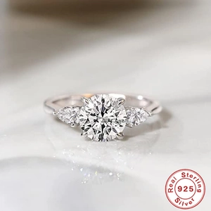 Macro view of sterling 925 silver ring featuring round and pear cut sparkling cubic zirconia