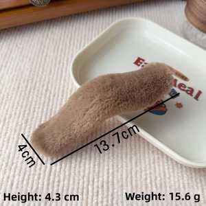 Detail view of large 13.7cm brown plush hair clip with soft faux fur texture