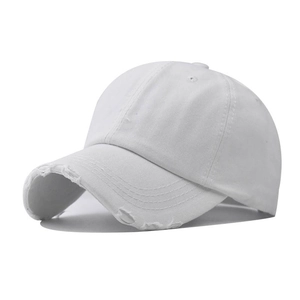 Detail of distressed white washed denim baseball cap showing fabric texture and worn edges