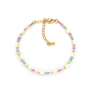 Bohemian beaded bracelet with freshwater pearls and gold beads on a white background