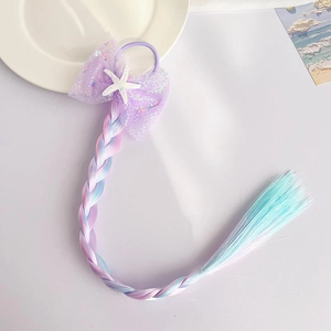 Detail of purple sequin bow hair clip with starfish and pink-blue gradient braid