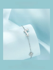 Detail of 925 sterling silver dachshund bracelet with cute puppy and paw print charm