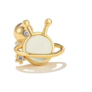 Detail of Saturn-shaped piercing stud with light green bead and gold-plated screw back ball
