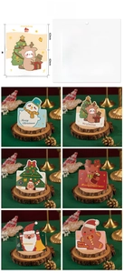 Close-up of 6 3D Christmas greeting cards featuring Santa, deer, and snowman motifs