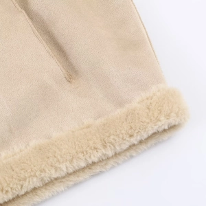 Detailed close-up of beige jacket fabric showing premium stitching and fleece lining texture