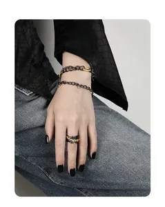 Close-up of S925 silver chain bracelets and lava texture ring on model hand