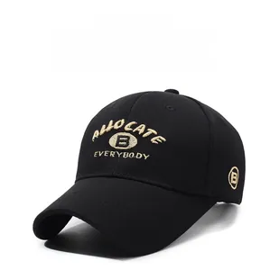 Close-up of beige letter embroidery on a black cotton baseball cap with six-panel design