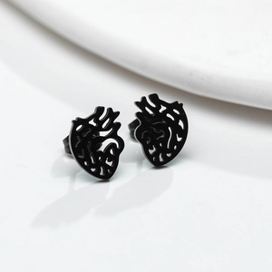 Macro shot of matte black anatomical heart stud earrings crafted from stainless steel