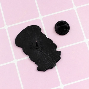 Macro shot of black enamel pin back with single post and secure rubber clutch fastener