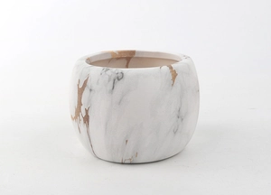 Detailed view of a white ceramic succulent pot with grey marble and gold foil pattern