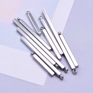 Close-up of slender silver 304 stainless steel bar pendants with rings for DIY jewelry