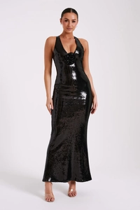 Close-up of black sequined evening dress with 3D flower detail and sexy open back design