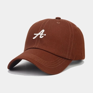 Detailed view of white 3D letter A embroidery on a premium brown cotton baseball cap